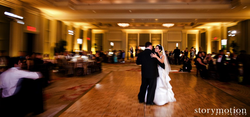 A first dance in a gold ballroom